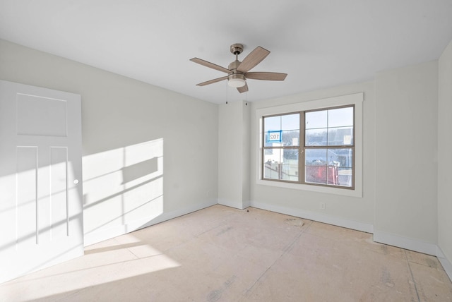 unfurnished room with baseboards and ceiling fan