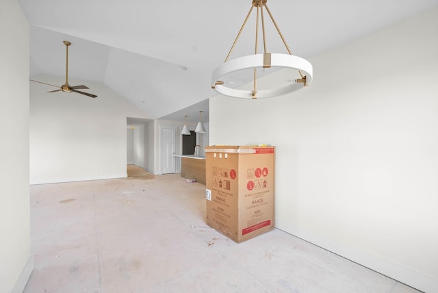 interior space with ceiling fan, baseboards, and lofted ceiling