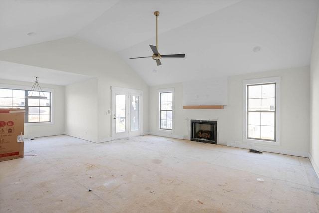 unfurnished living room featuring high vaulted ceiling, a fireplace, a wealth of natural light, and ceiling fan