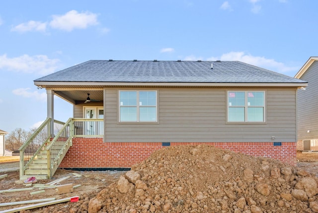 rear view of house featuring crawl space, roof with shingles, and covered porch