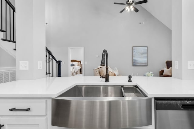 kitchen with visible vents, a sink, stainless steel dishwasher, white cabinets, and light countertops