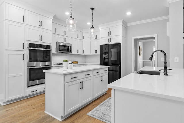 kitchen with tasteful backsplash, a kitchen island, crown molding, stainless steel appliances, and a sink