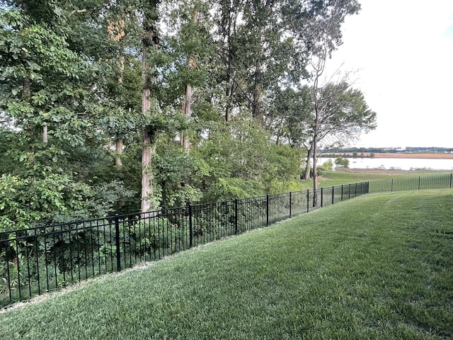 view of yard with fence and a water view