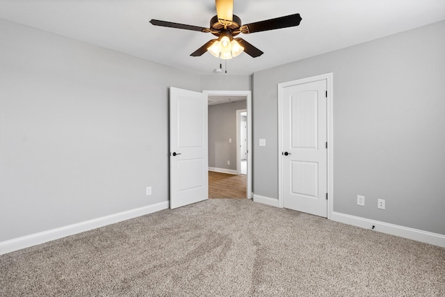 unfurnished bedroom with baseboards, carpet, and ceiling fan