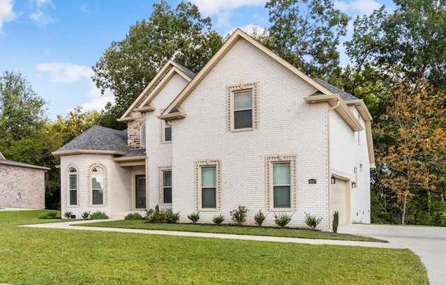 view of front of home featuring brick siding, a garage, concrete driveway, and a front lawn