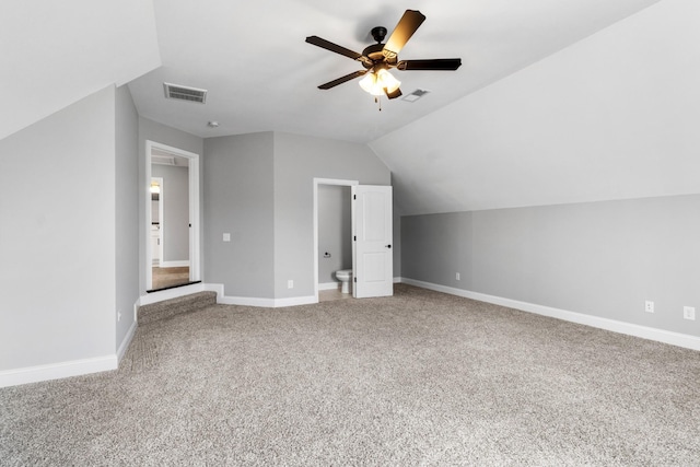 additional living space featuring lofted ceiling, baseboards, visible vents, and carpet floors