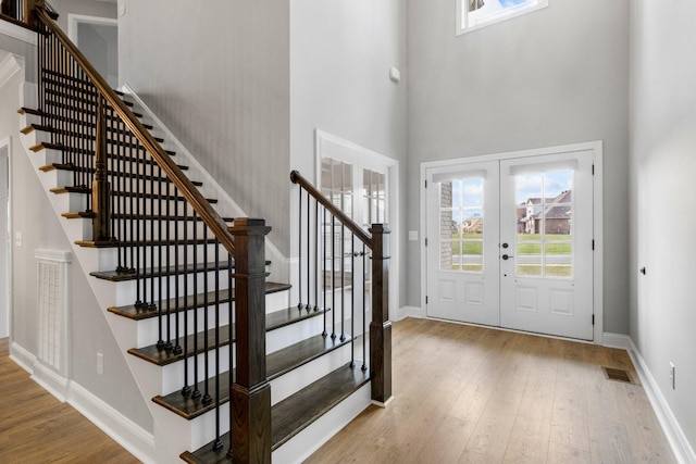 foyer with visible vents, french doors, baseboards, and hardwood / wood-style flooring