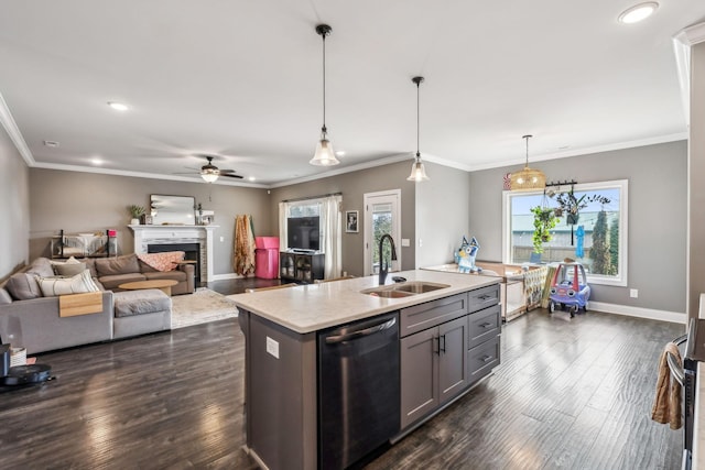 kitchen featuring baseboards, a fireplace, a sink, dark wood-type flooring, and stainless steel dishwasher