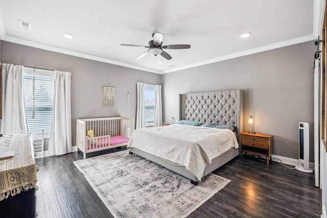 bedroom featuring dark wood finished floors, crown molding, baseboards, and visible vents