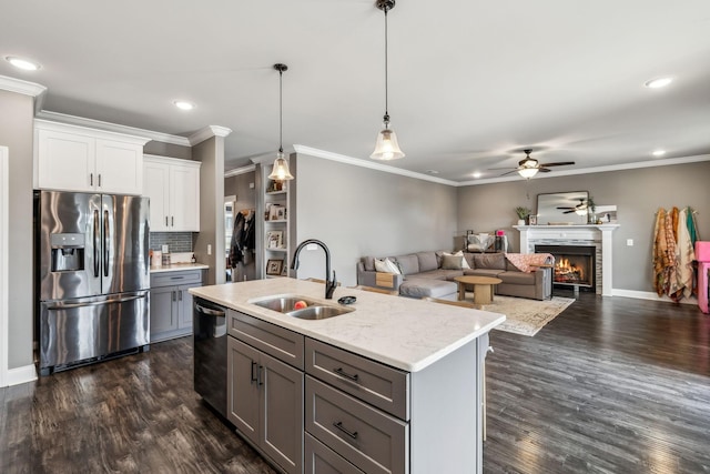 kitchen featuring a sink, gray cabinetry, dark wood finished floors, and stainless steel appliances