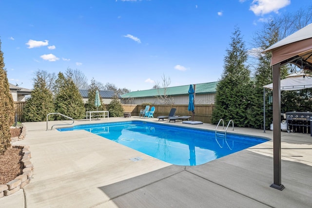 view of pool featuring a patio area, a fenced in pool, and a fenced backyard