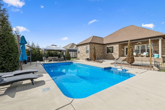 view of swimming pool with a gazebo, a patio area, outdoor lounge area, and fence