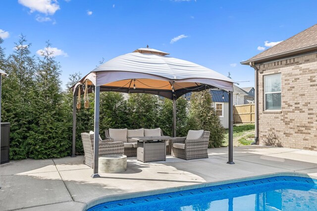 view of patio / terrace featuring an outdoor pool, an outdoor hangout area, and fence