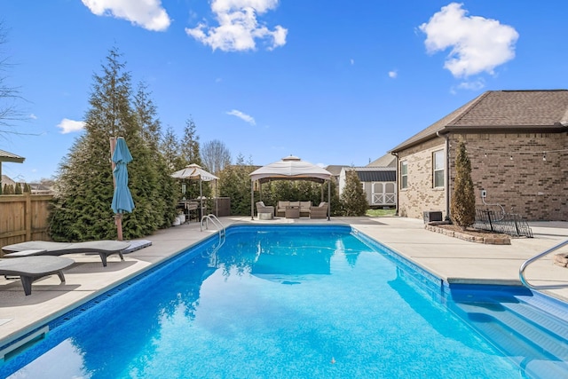 view of swimming pool with a fenced in pool, a patio, outdoor lounge area, and fence