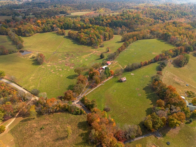 drone / aerial view featuring a rural view and a view of trees