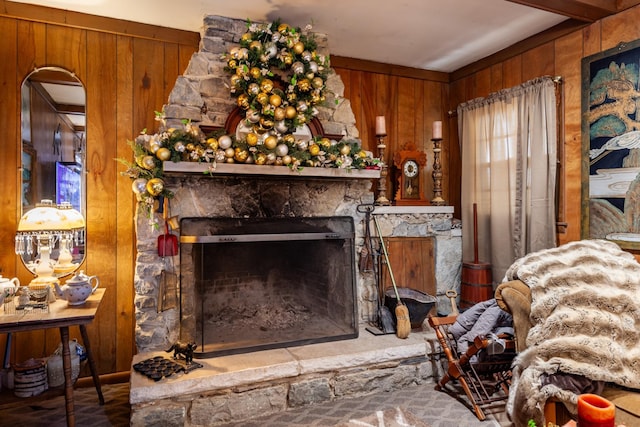 living room with wood walls and a fireplace