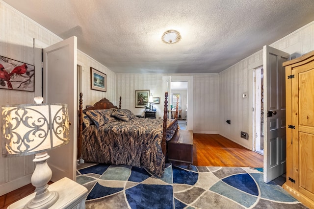 bedroom featuring a textured ceiling and wood finished floors