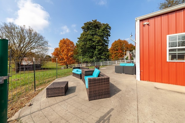 view of patio featuring outdoor lounge area and fence