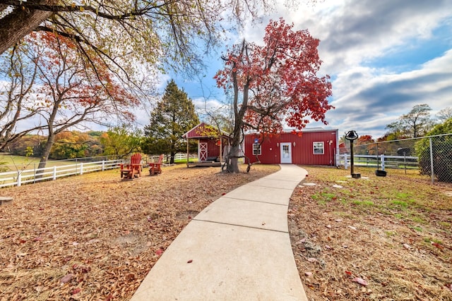 surrounding community featuring an outdoor structure and fence