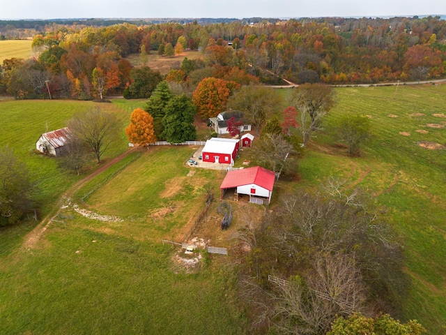 birds eye view of property with a rural view and a wooded view