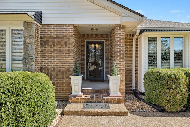 doorway to property with brick siding