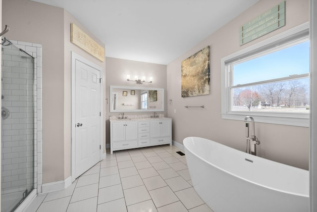 full bath with a sink, a soaking tub, double vanity, and a shower stall