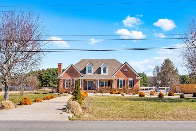 view of front of home with a front yard and fence