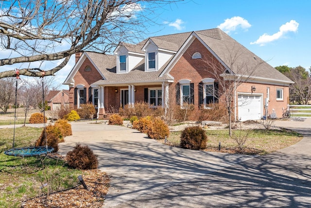 view of front facade with brick siding, an attached garage, a shingled roof, and driveway