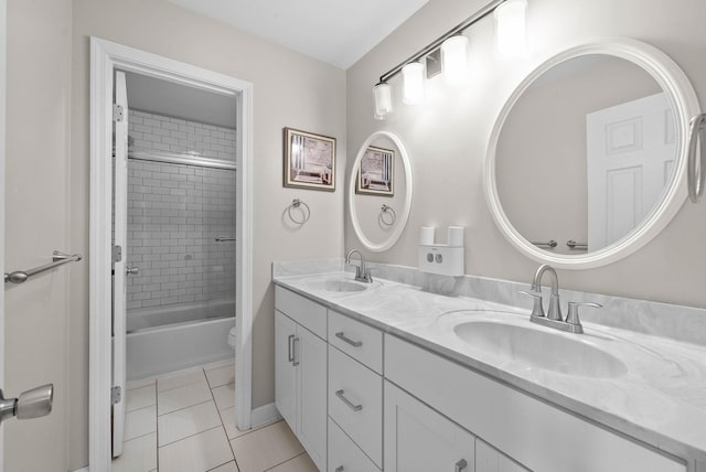 bathroom featuring a sink, shower / bathing tub combination, double vanity, and tile patterned floors