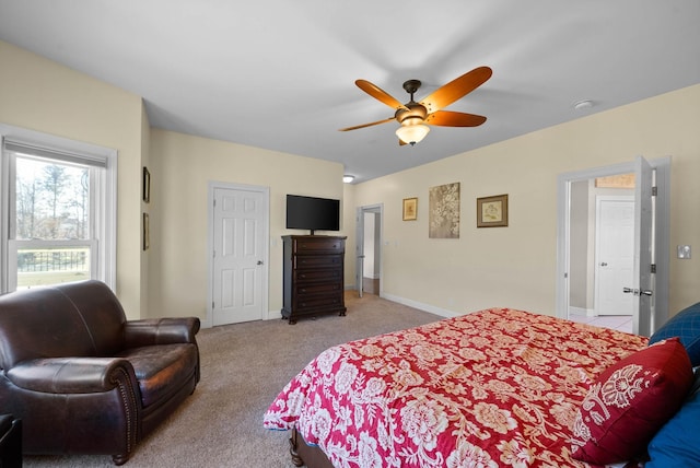 bedroom with a ceiling fan, light colored carpet, and baseboards