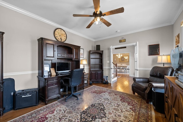 office with ornamental molding, ceiling fan with notable chandelier, baseboards, and wood finished floors