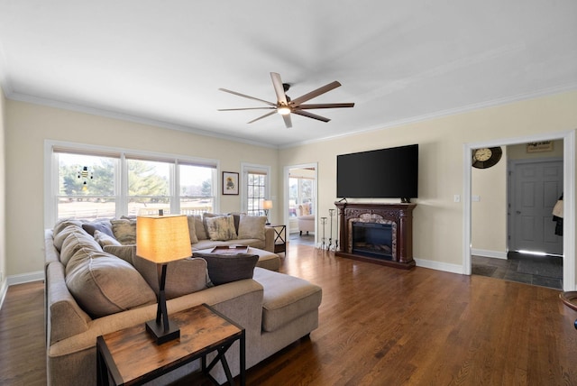 living area featuring ceiling fan, baseboards, dark wood finished floors, and a fireplace