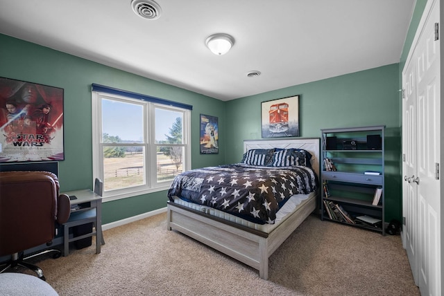 carpeted bedroom with visible vents and baseboards