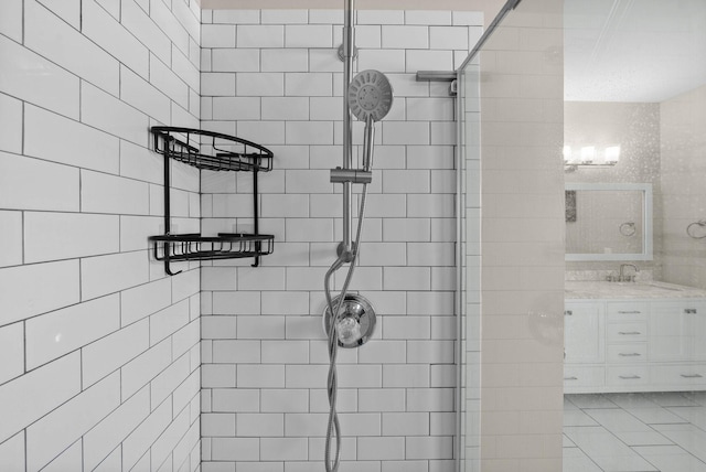 bathroom featuring vanity and tiled shower