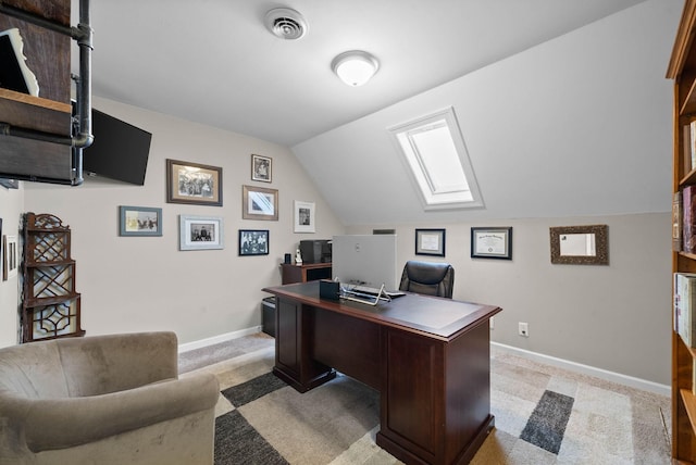 office area with lofted ceiling with skylight, visible vents, light colored carpet, and baseboards