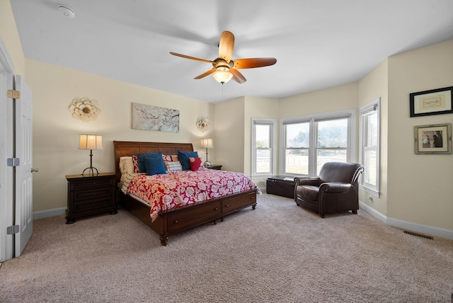 bedroom featuring visible vents, baseboards, carpet floors, and ceiling fan