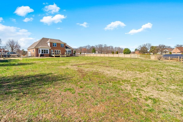 view of yard featuring a rural view and fence