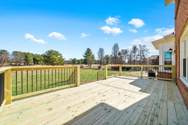 wooden terrace with a lawn