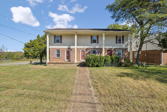 view of front of home featuring brick siding and a front yard