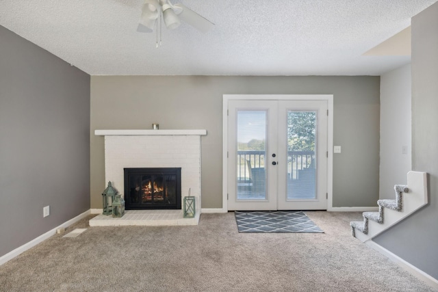 unfurnished living room with a fireplace, carpet flooring, french doors, and baseboards