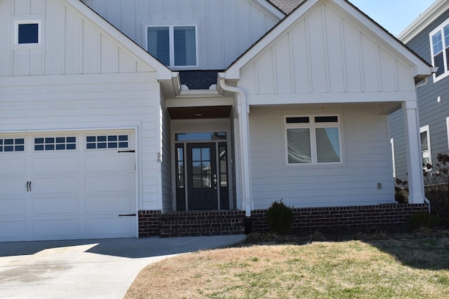 view of front of property featuring a garage, roof with shingles, board and batten siding, and driveway