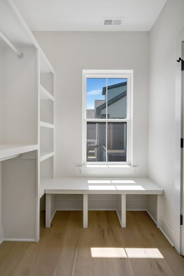 interior space featuring wood finished floors and visible vents