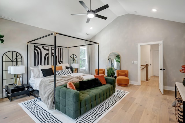 bedroom featuring baseboards, ceiling fan, high vaulted ceiling, and light wood-style floors