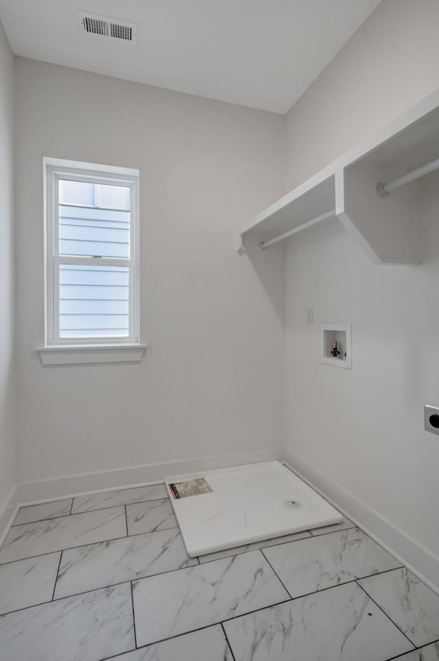 clothes washing area featuring visible vents, baseboards, laundry area, hookup for a washing machine, and electric dryer hookup