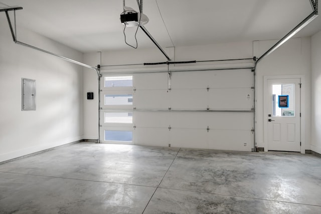 garage featuring electric panel, baseboards, and a garage door opener