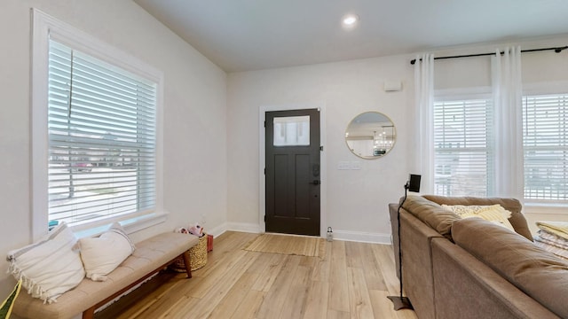 entryway featuring light wood-type flooring and baseboards