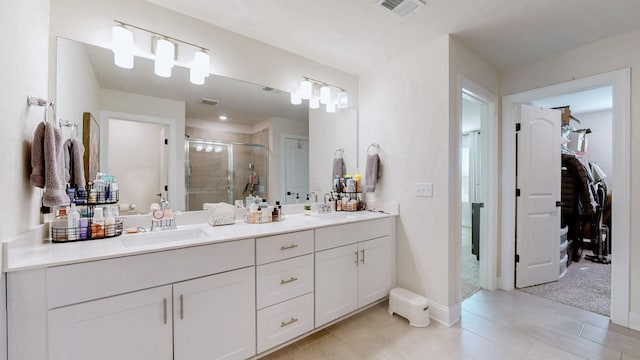 full bath with double vanity, visible vents, a stall shower, and a sink