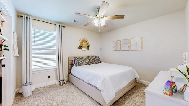 bedroom with light carpet, visible vents, ceiling fan, and baseboards