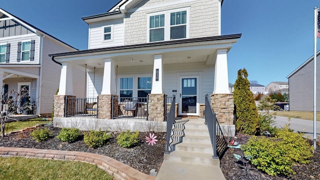 view of front facade featuring stone siding and a porch