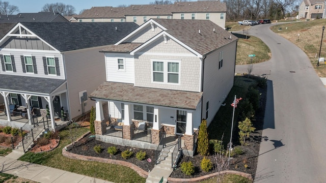 craftsman-style house with a porch and a shingled roof